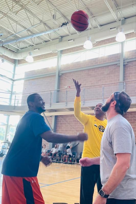 NBA legend Alex English tips off to Aflac Employee Team member, Quan Prowell (left) and Aflac Leaders Team member, Cary Allen (right).