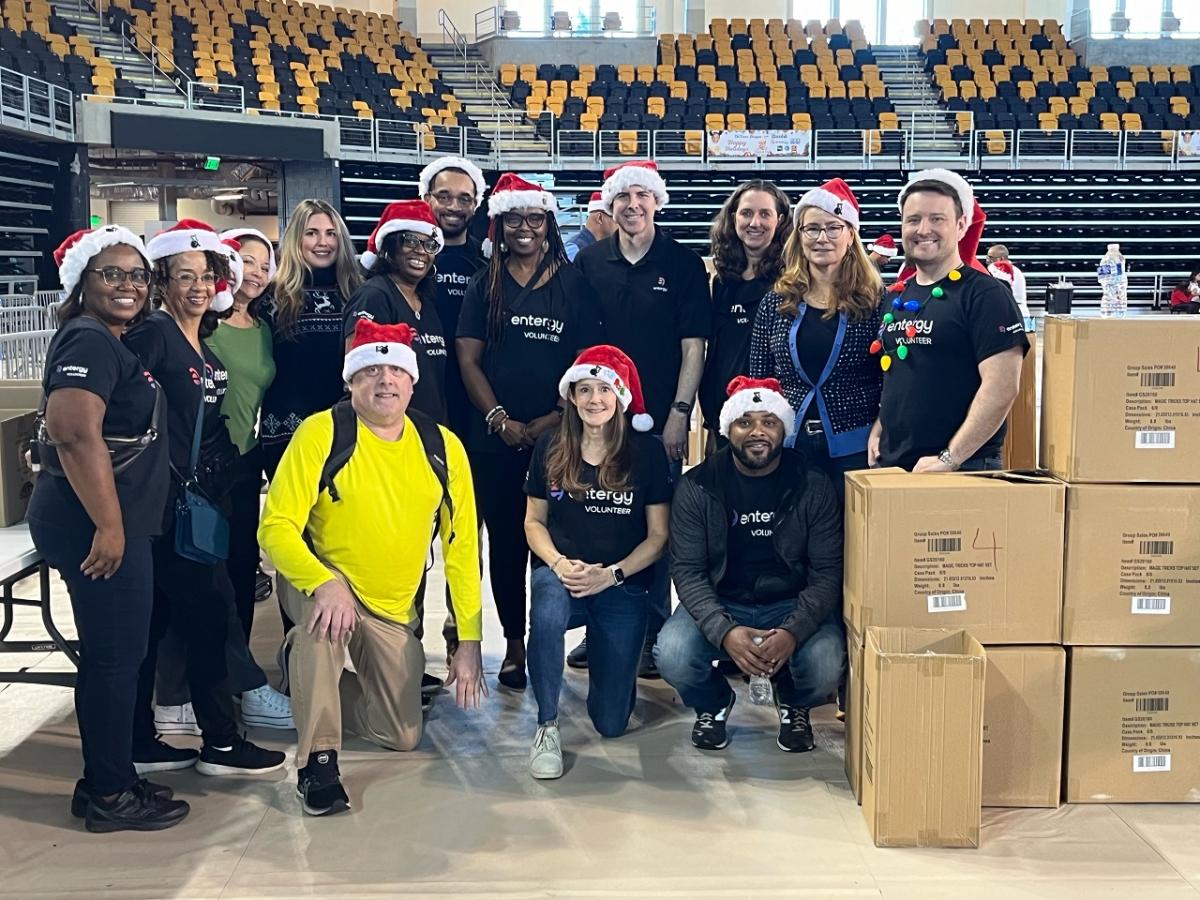 A group of posed volunteers in santa hats.