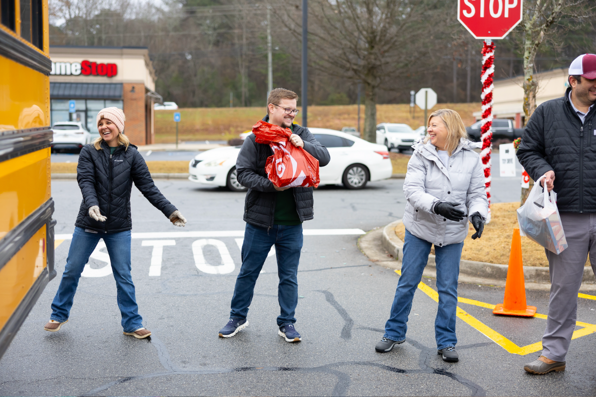 Volunteers handing presents off