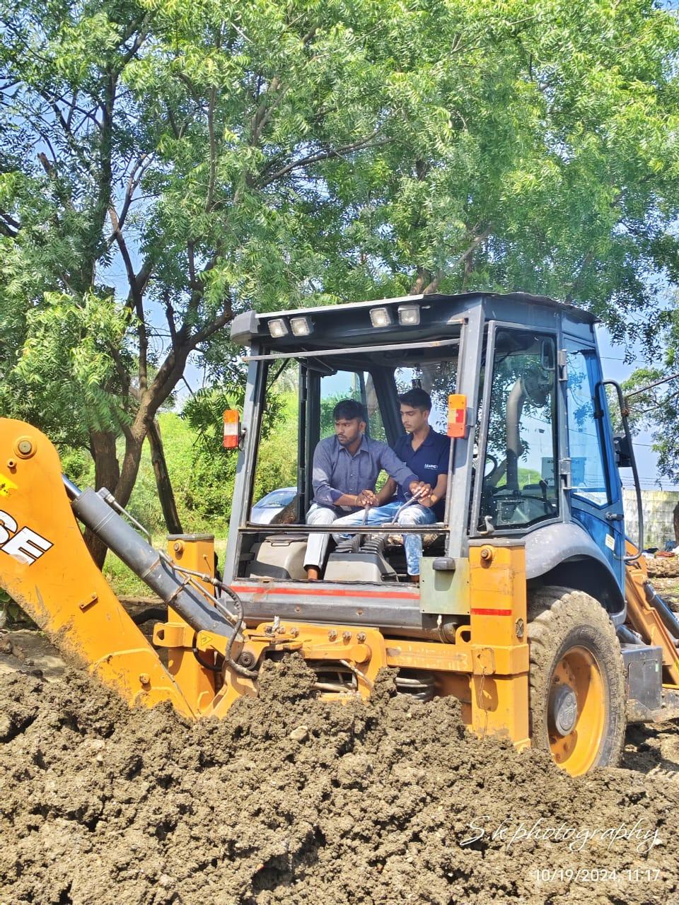 Someone being trained in operating farm machinery