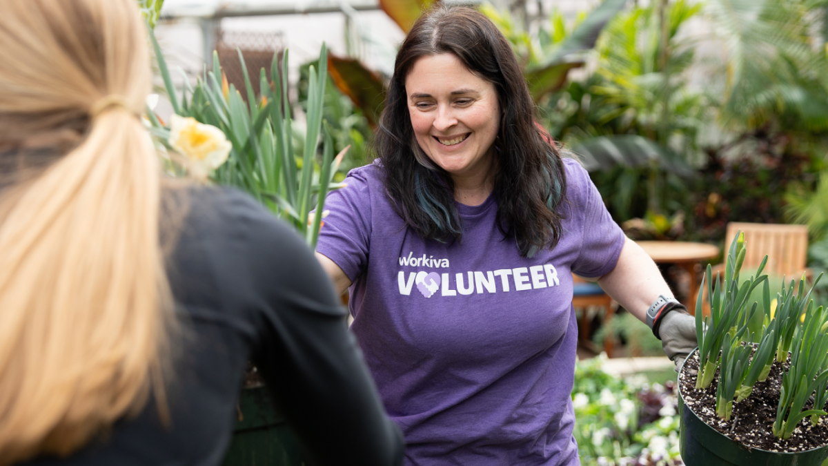 A Workiva volunteer working with plants