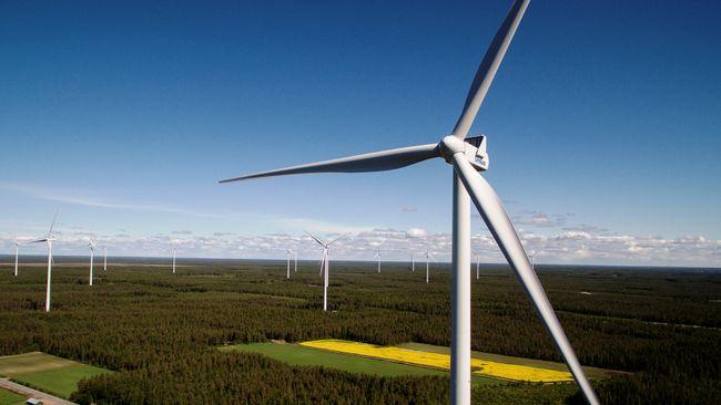 aerial view of wind turbines  over miles of flat land