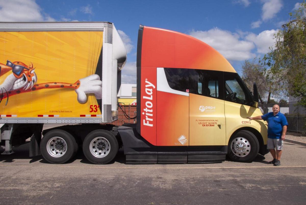Eric Tutorow in Manteca, Calif., with one of the Tesla electric semi trucks he drives for Frito-Lay. Courtesy of WBUR - Chris Bentley/Here & Now " "
