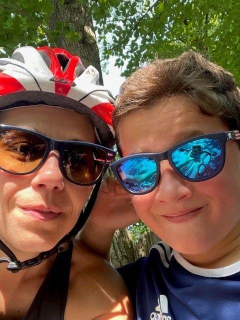 Two people taking a selfie, One has a bike helmet on.