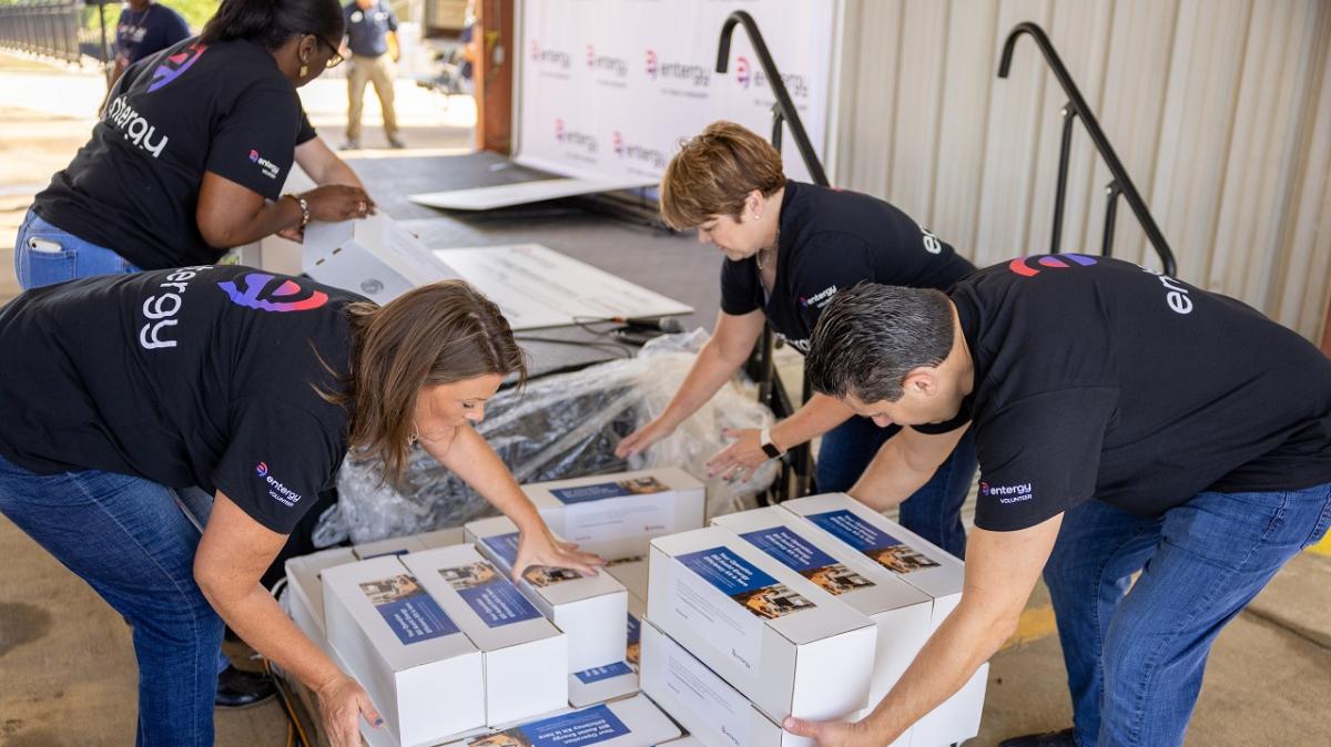 Volunteers un wrapping boxes.