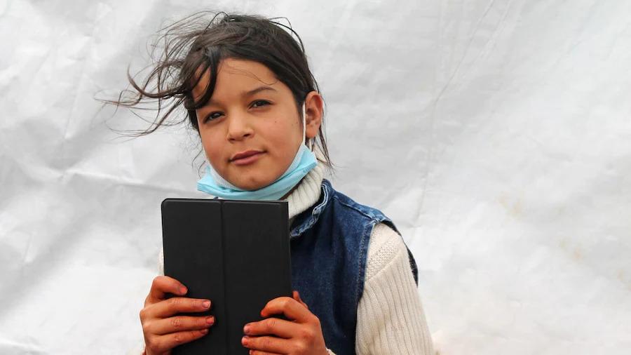 A child holding an electronic tablet