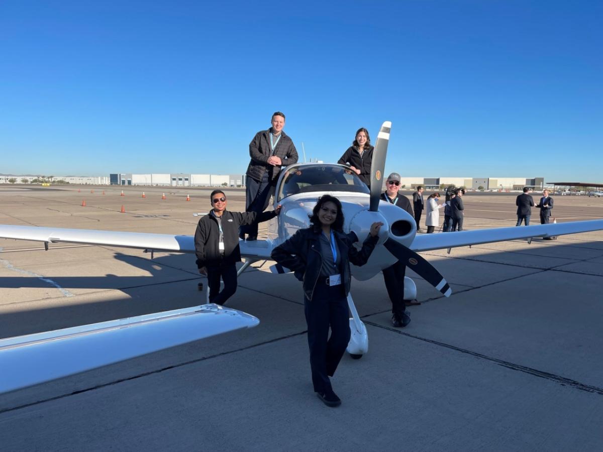 Natalie Villalpando, front, and others around a small aircraft