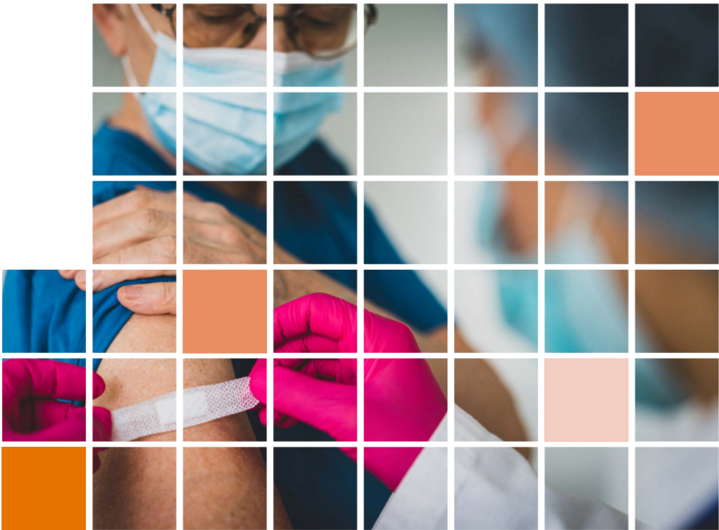 A medical provider in ppe puts a band-aid on the arm of another person wearing a protective mask.