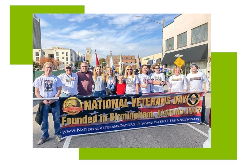 Chris Parker, far left, and his family lead the Birmingham Veterans Day parade. Group of people holding a Veterans day banner