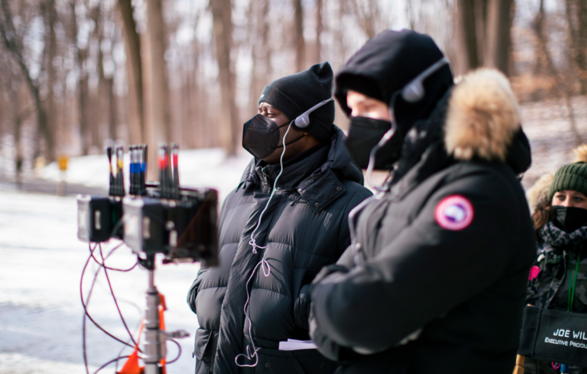 CBS, The Equalizer Movie crew outside in cold weather gear, protective masks and headphones. Equipment in front of them.