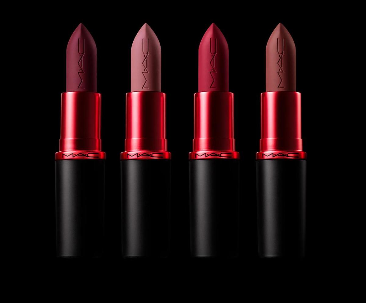 Four different color lipsticks on a black background