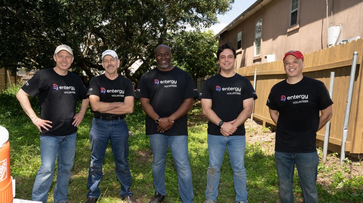 Five volunteers posed outside in matching shirts.