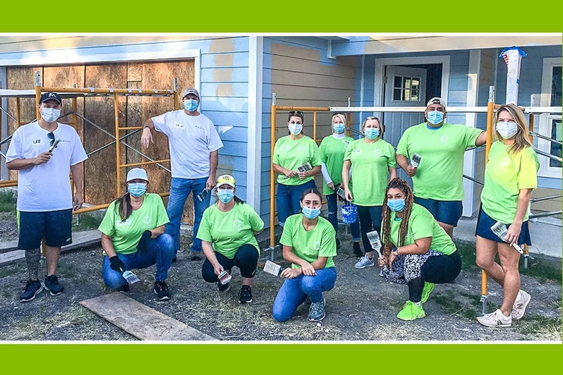 Volunteers outside a home