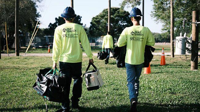 Two workers with Duke Energy t-shirts