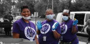 Three volunteers wearing rubber gloves