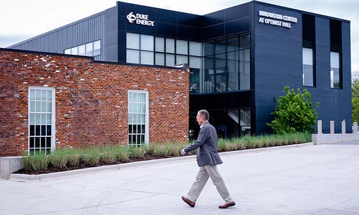 Zhang walking towards a large building