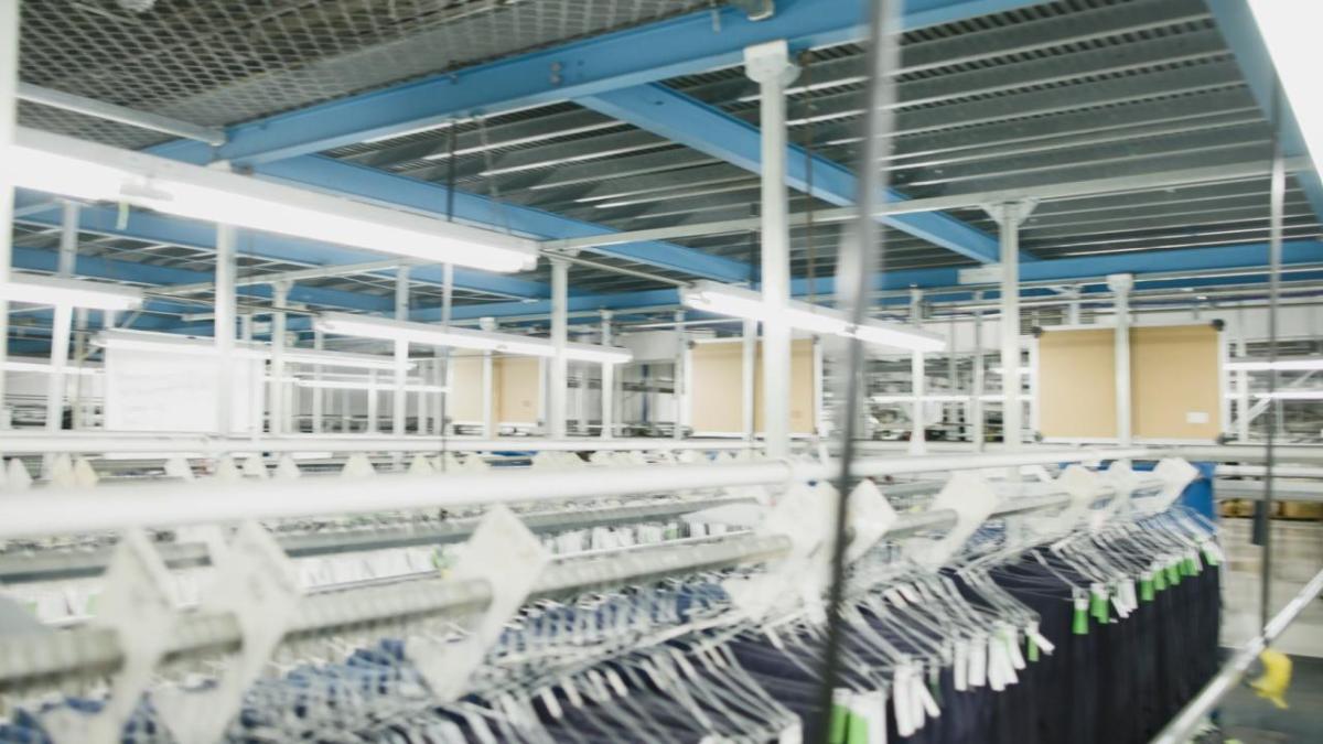 A warehouse with rows of racks of hanging clothing