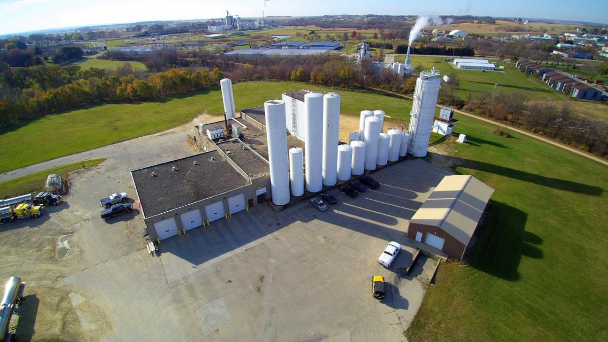 Aerial view of a warehouse, multiple buildings and storage towers.