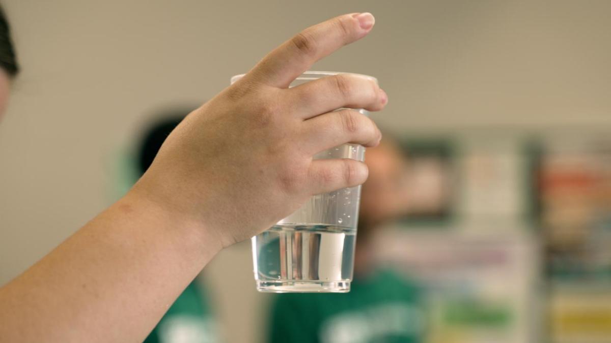 Person holding a glass of water