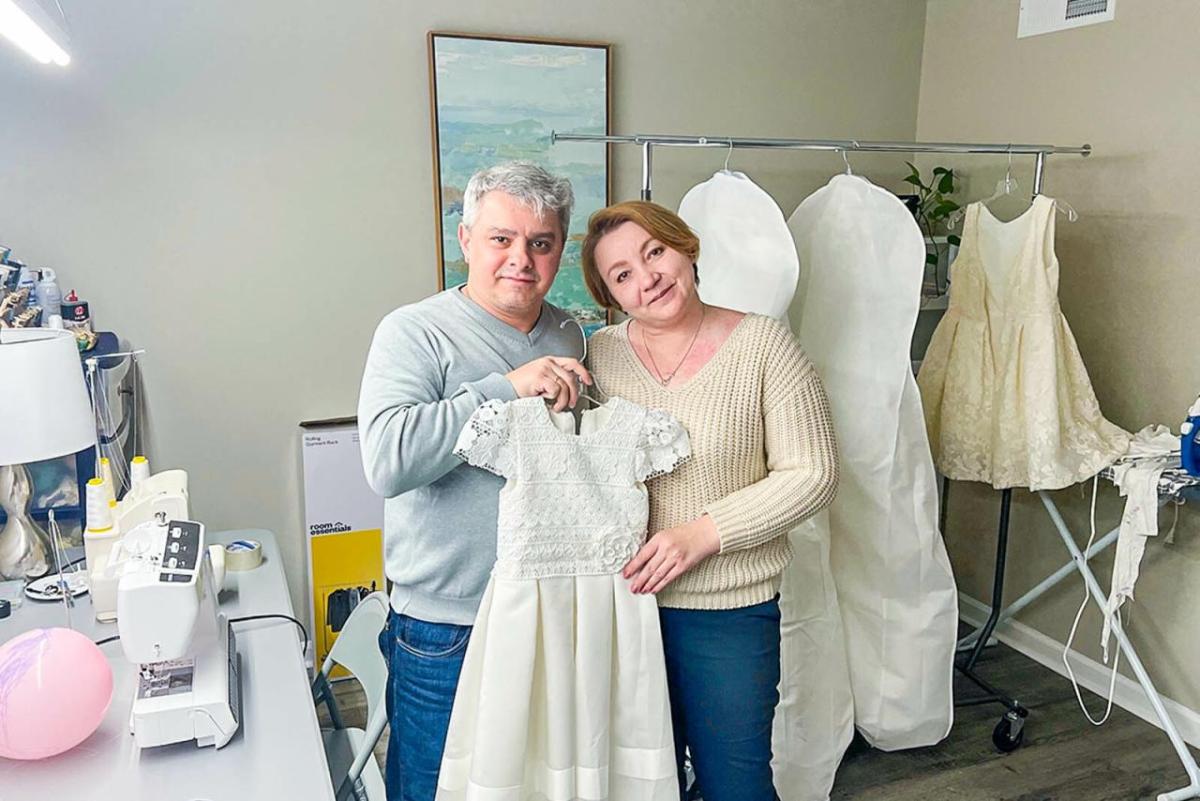 Mykola and Olena Vyshyvanyuk show off a recent dress created for a wedding.