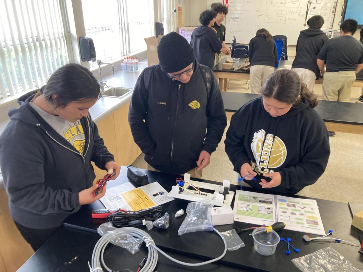 A team of students working on solar battery kit.