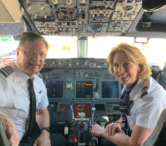 two pilots in the cockpit of a plane
