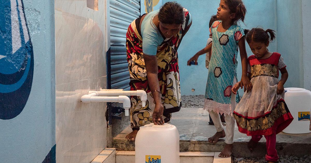 woman and children collect water