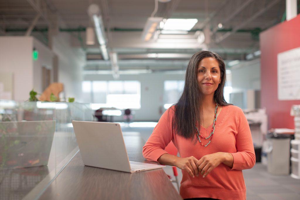 woman standing next to a computer