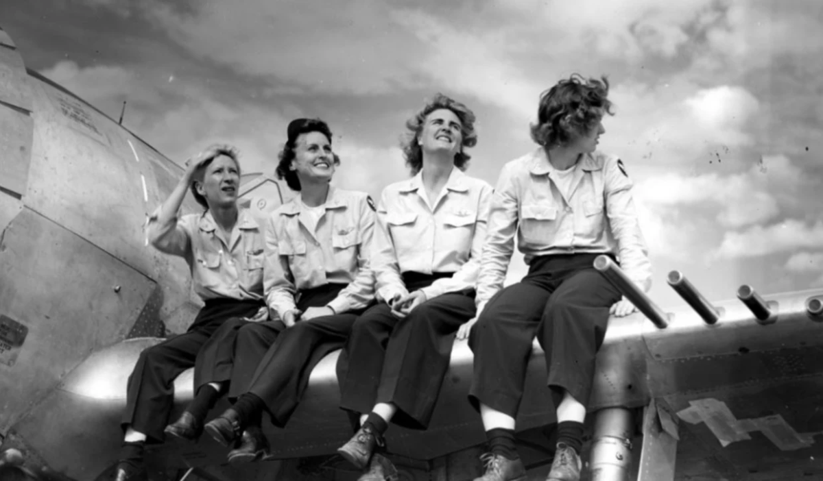 women pilots on wing of plane