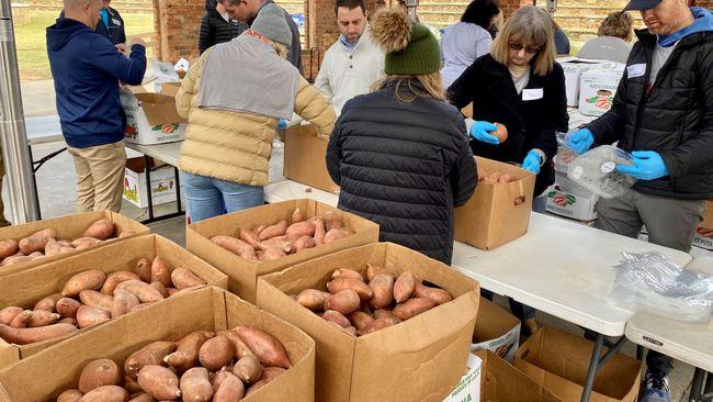 Volunteers sorting and packing yams.