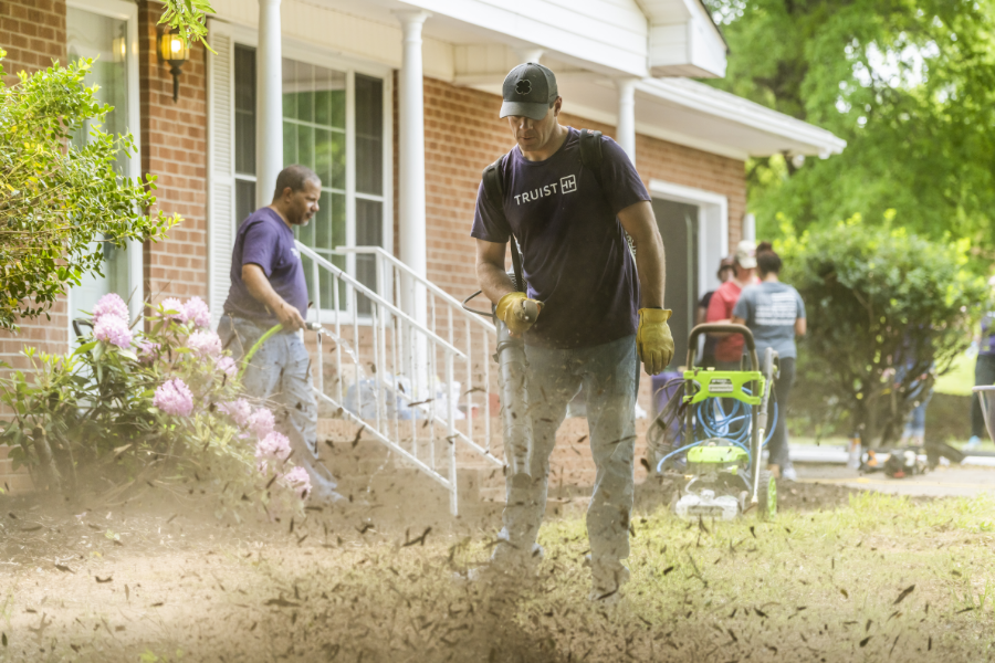 volunteers doing yard work outside the new home