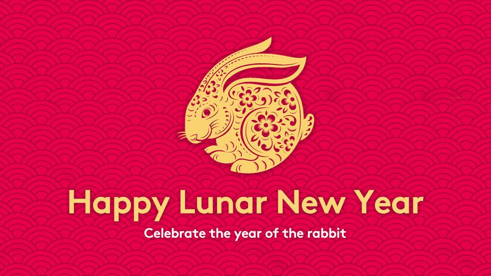 On a red background, a gold, intricately designed rabbit, and "Happy Lunar New Year Celebrate the year of the rabbit."