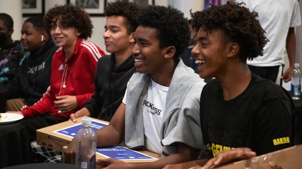 Young men from the Hidden Genius Project in Oakland receiving their free personal laptops.