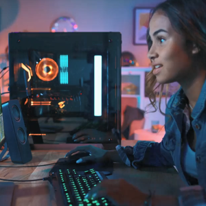A person playing a game on a desktop computer, using the keyboard as a controller. 