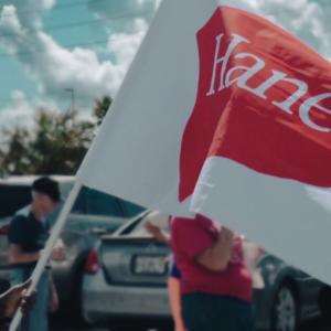 Woman holding a HanesBrands flag.
