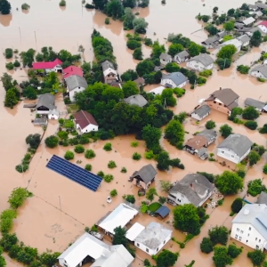 aerial view of a flooded neighborhood, many buildings fully or partially submerged.
