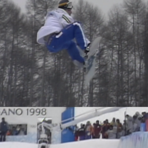 Snowboarder in the air on a half-pipe run.