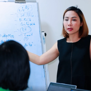 Van Pham in front of a white board