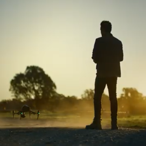 Silouette of man with flying a drone