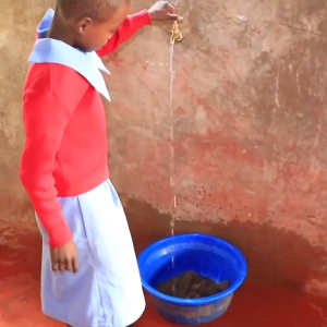 Child turning on a tap 