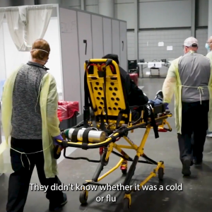 Person laid on a stretcher surrounded by medical staff