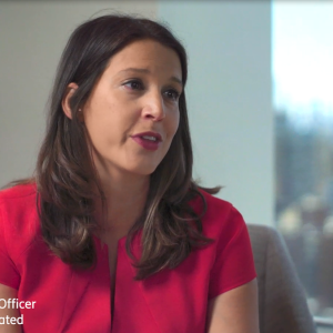 Angela Baker speaking in an office setting.