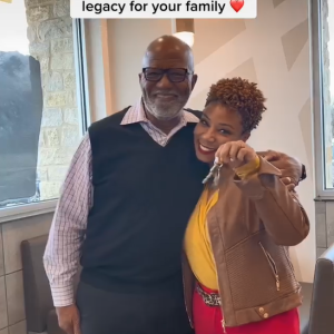 Aaron Harris and Joy Silmon with arms around each other, Joy holds a set of keys.