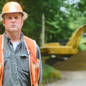 Matt Poppe. A large bucket crane behind them.