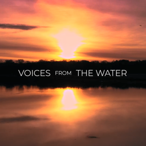 "Voices from the water" on a background of an expanse of water reflecting trees on a horizon at sunset.