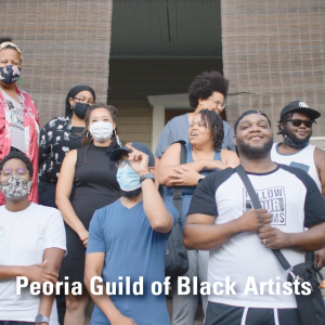 A group of people on steps outside a brick building. "Peoria Guild of Black Artists"