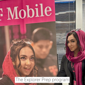 Daaniya standing next to a T-Mobile poster that features her.