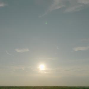 Sun rising over a flat landscape