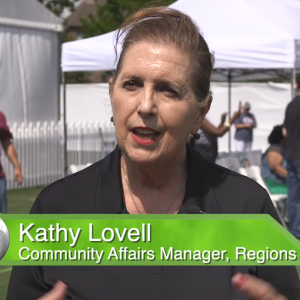 Kathy Lovell, in front of open shade tents.