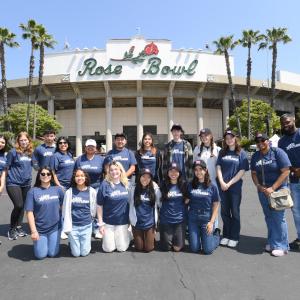 Students pose in front of the Rose Bowl stadium.